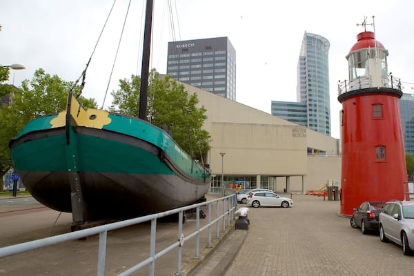 Ein großes, grün-gelbes Boot, ein roter Leuchtturm und moderne Gebäude, darunter das Maritimemuseum.
