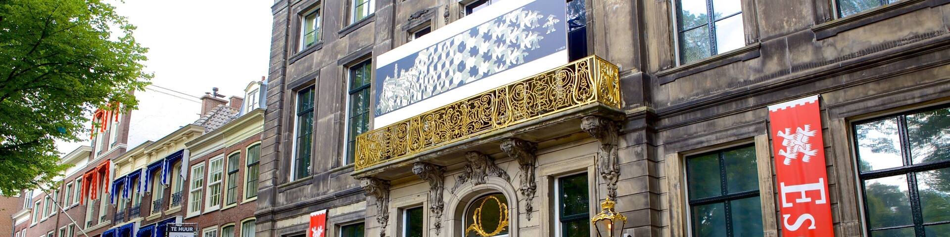 A historic building with ornate decorations and banners.