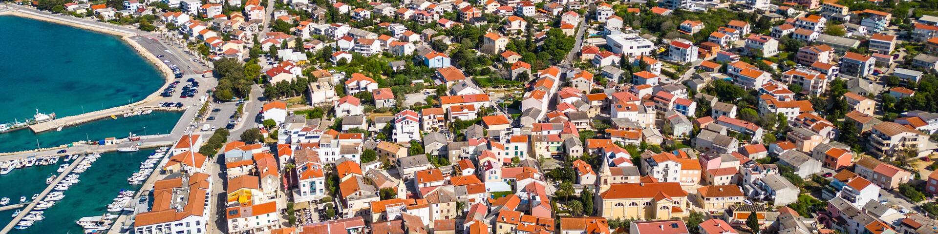 Aerial view of Novalja on Pag Island, Croatia. Famous for its beaches, vibrant summer atmosphere, and scenic Adriatic coastline. Captured by drone for a stunning panoramic perspective