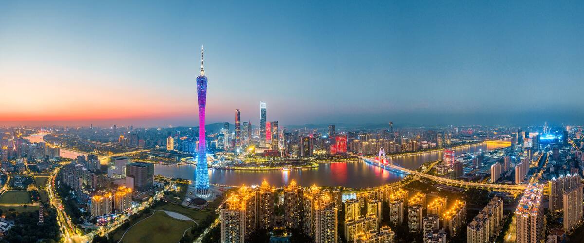 A cityscape with a prominent tower, a river, and surrounding high-rise buildings.