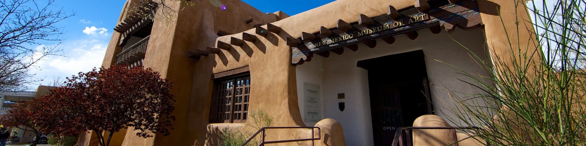 A building with a distinctive architectural style, featuring a tower and a covered entrance.