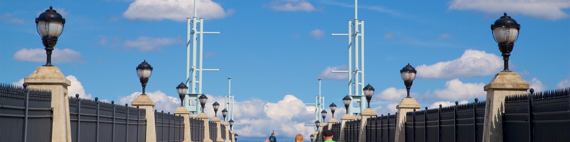 Hudson River Way showing a bridge as well as a family