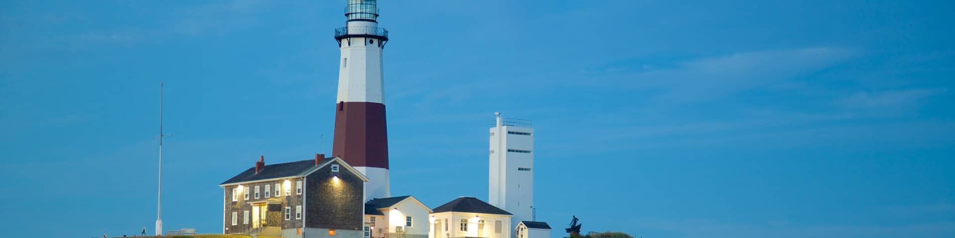 Montauk Point Lighthouse featuring rocky coastline, a lighthouse and a sandy beach
