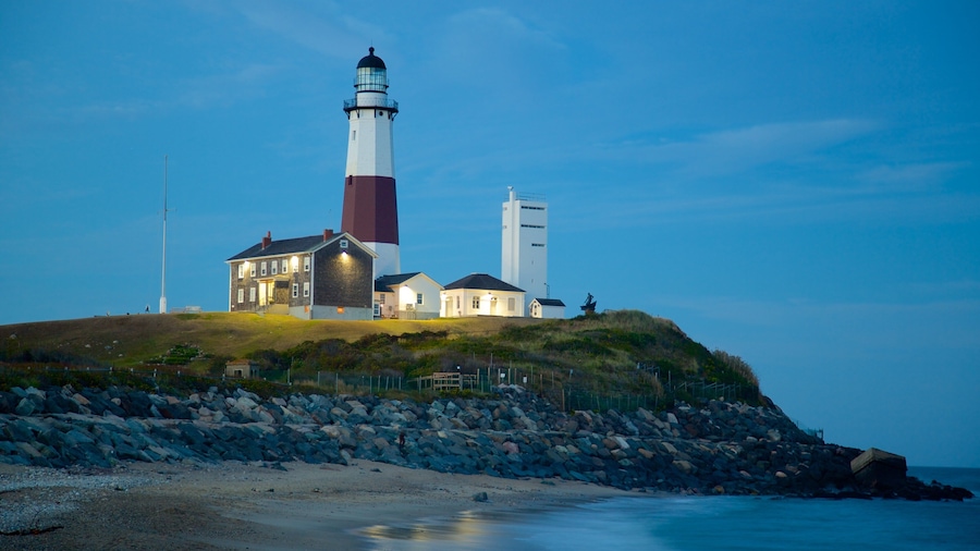 Montauk Point Lighthouse featuring rocky coastline, a lighthouse and a sandy beach