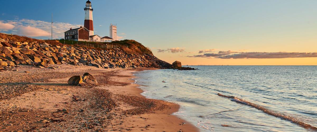 Montauk Lighthouse and beach at sunrise, Long Island, New York, USA.