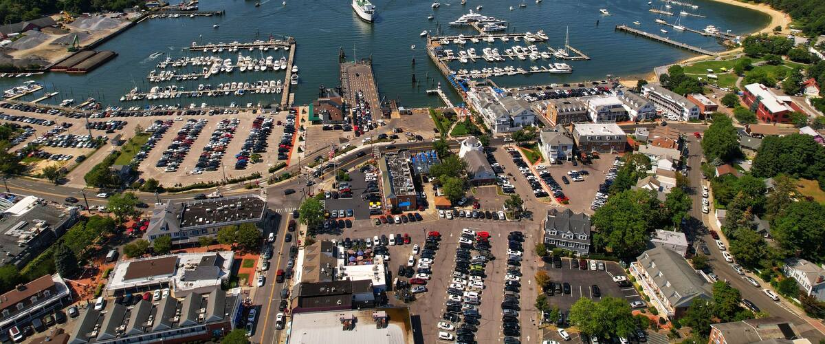 Aerial view of the bustling Port Jefferson Harbor, surrounded by many boats of various sizes