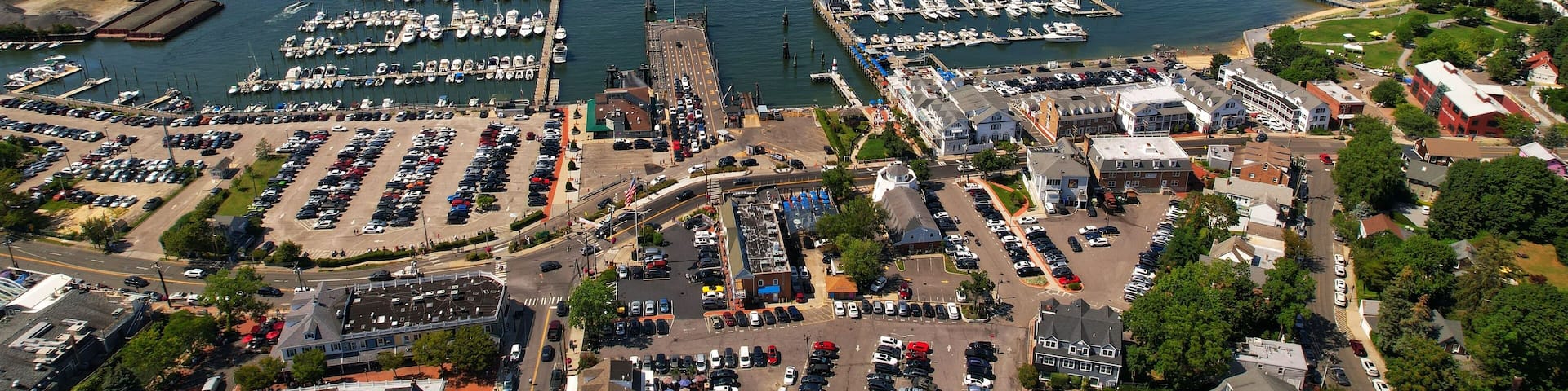 Aerial view of the bustling Port Jefferson Harbor, surrounded by many boats of various sizes