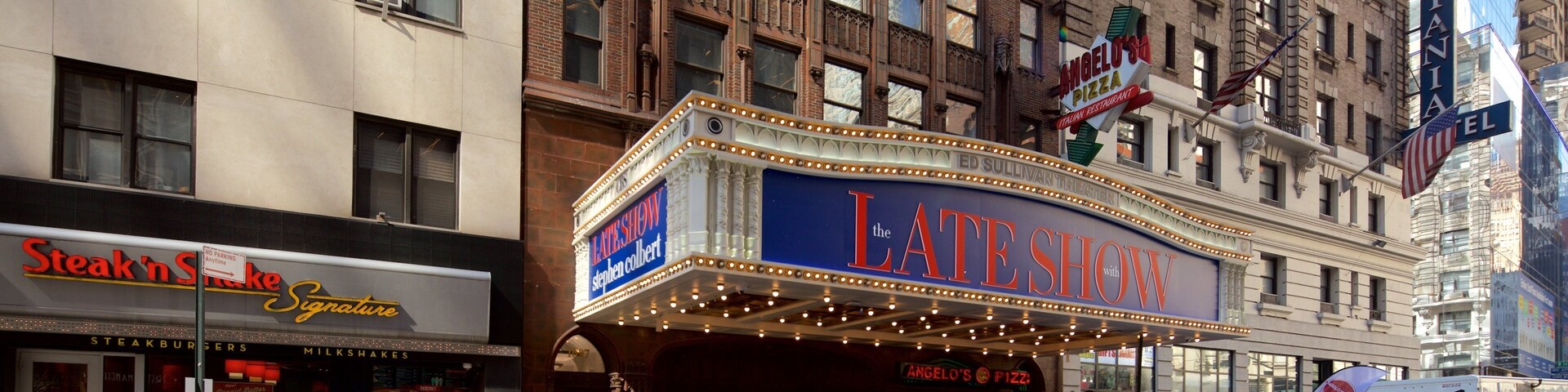 Ed Sullivan Theater which includes a city and signage as well as a large group of people