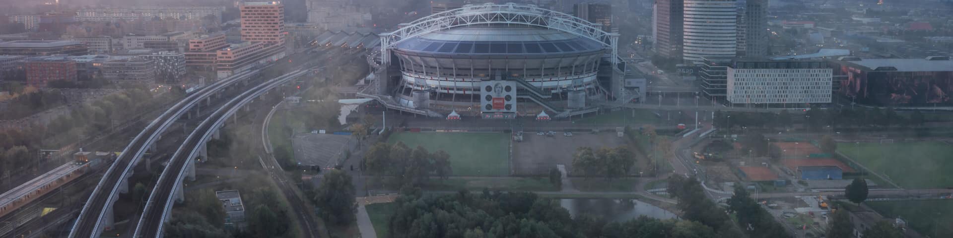 Amsterdam, Netherlands - 04 October 2022: Aerial view of the Johan Cruijff Arena, a stadium at sunset with fog in Amsterdam, the Netherlands.