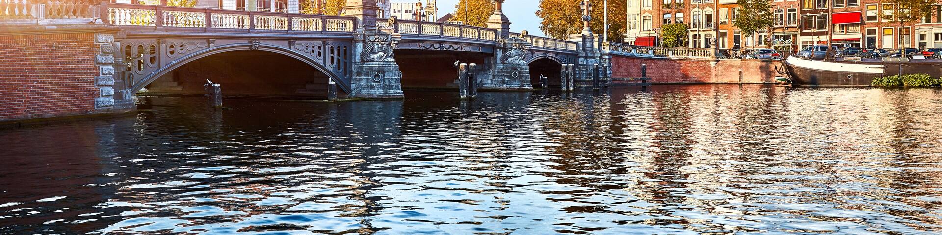 Panorama of Blue Bridge (Blauwbrug) in Amsterdam on river