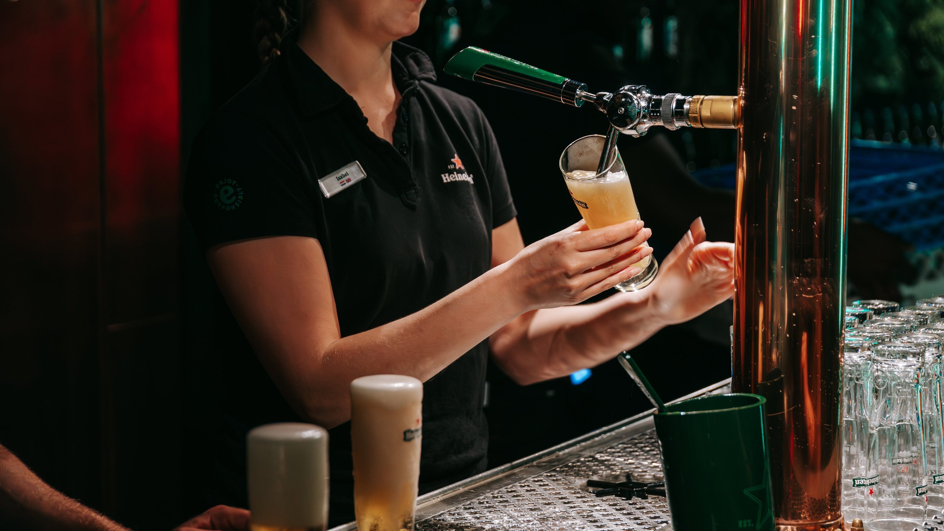 Heineken Experience showing a bar and drinks or beverages as well as an individual femail