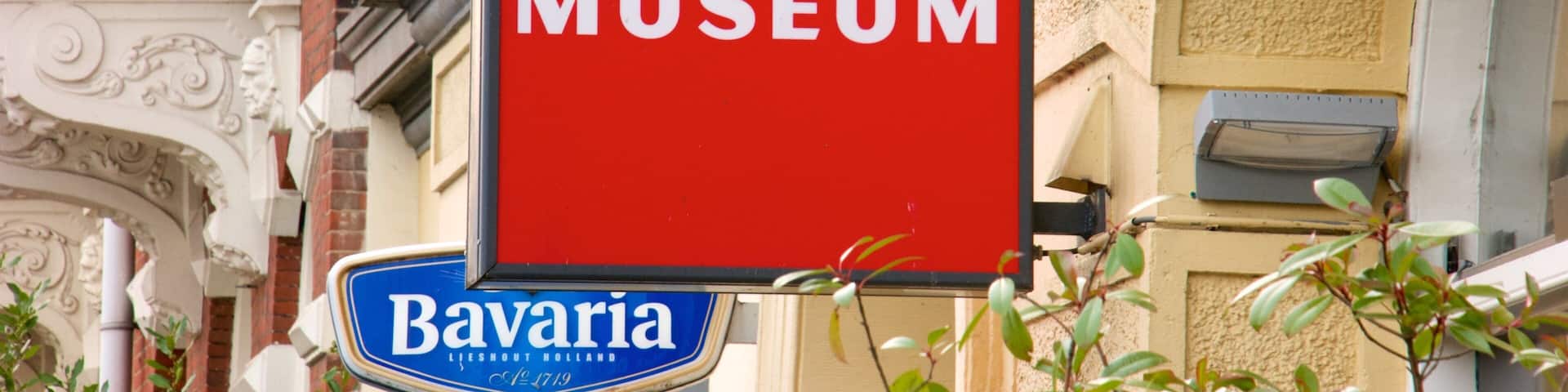 A sign for Verzets Museum and a Bavaria sign.