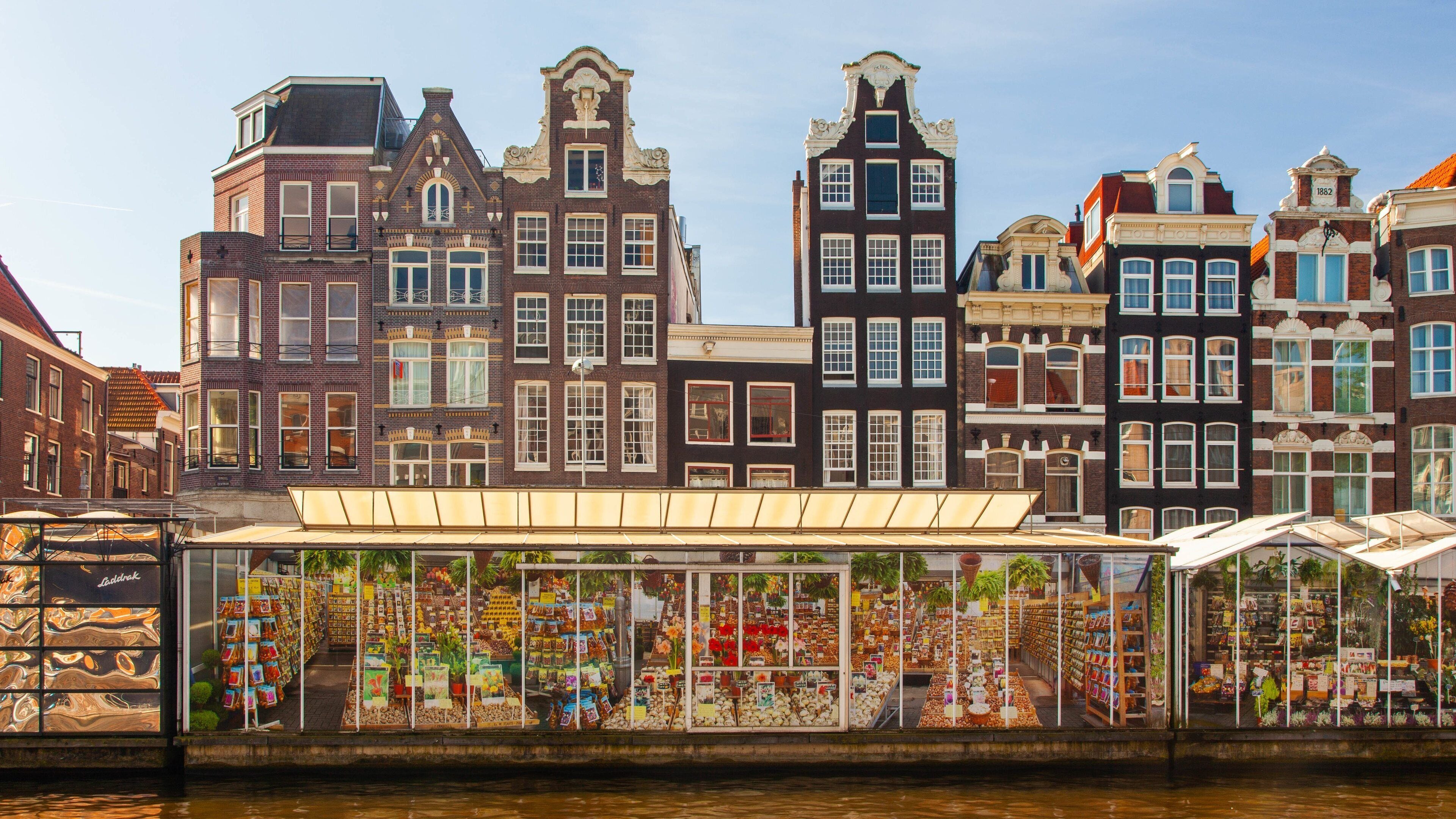 A canal with historic buildings and a flower market.