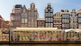 A canal with historic buildings and a flower market.