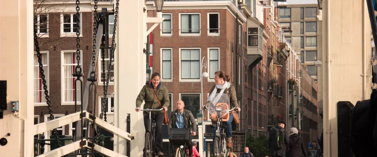 Magere Brug showing a bridge, cycling and a small town or village
