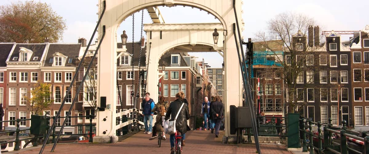 Magere Brug which includes a bridge, a small town or village and cycling