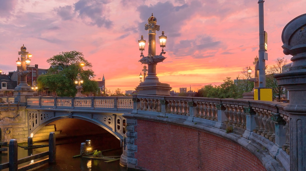 Blauwbrug Blue Bridge over Amstel river in Amsterdam at sunset spring evening, Holland.