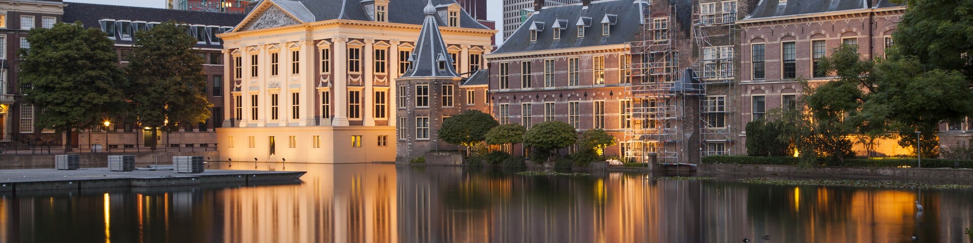 Evening view on Binnenhof Palace and high modern buildings in Hague