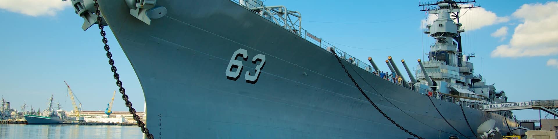 USS Missouri Memorial which includes military items, a bay or harbor and a marina