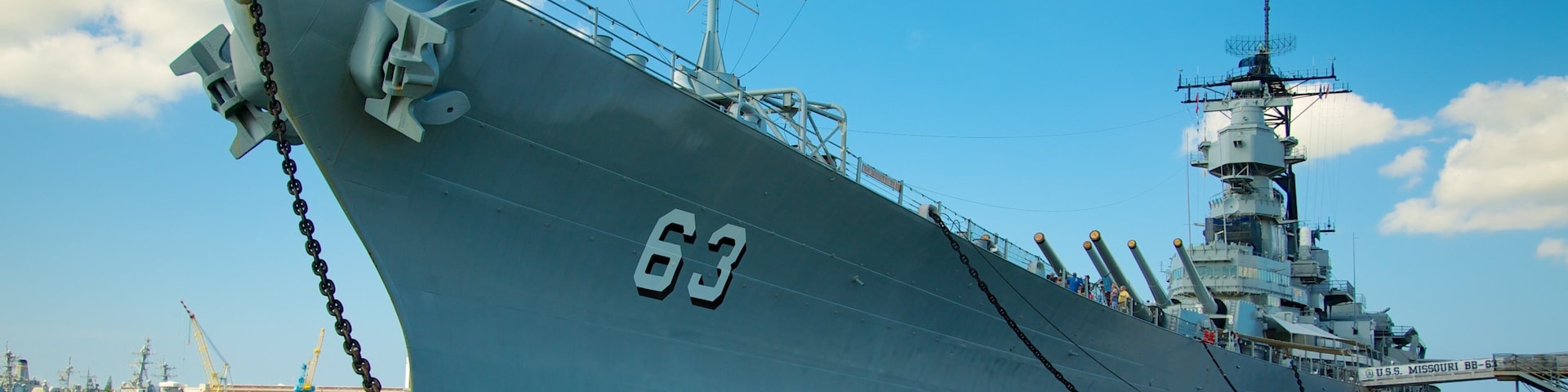 USS Missouri Memorial which includes military items, a bay or harbor and a marina