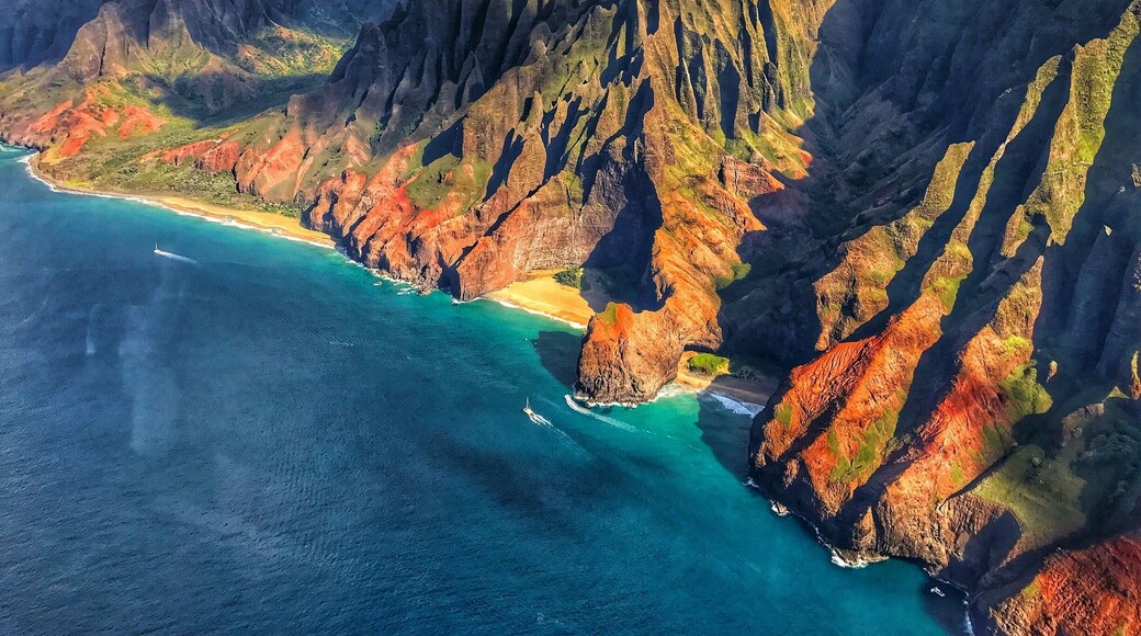 When visiting Kauai , it's money well spend to take a helicopter tour. This was taken near the eastern end of the north shore . So many colors !