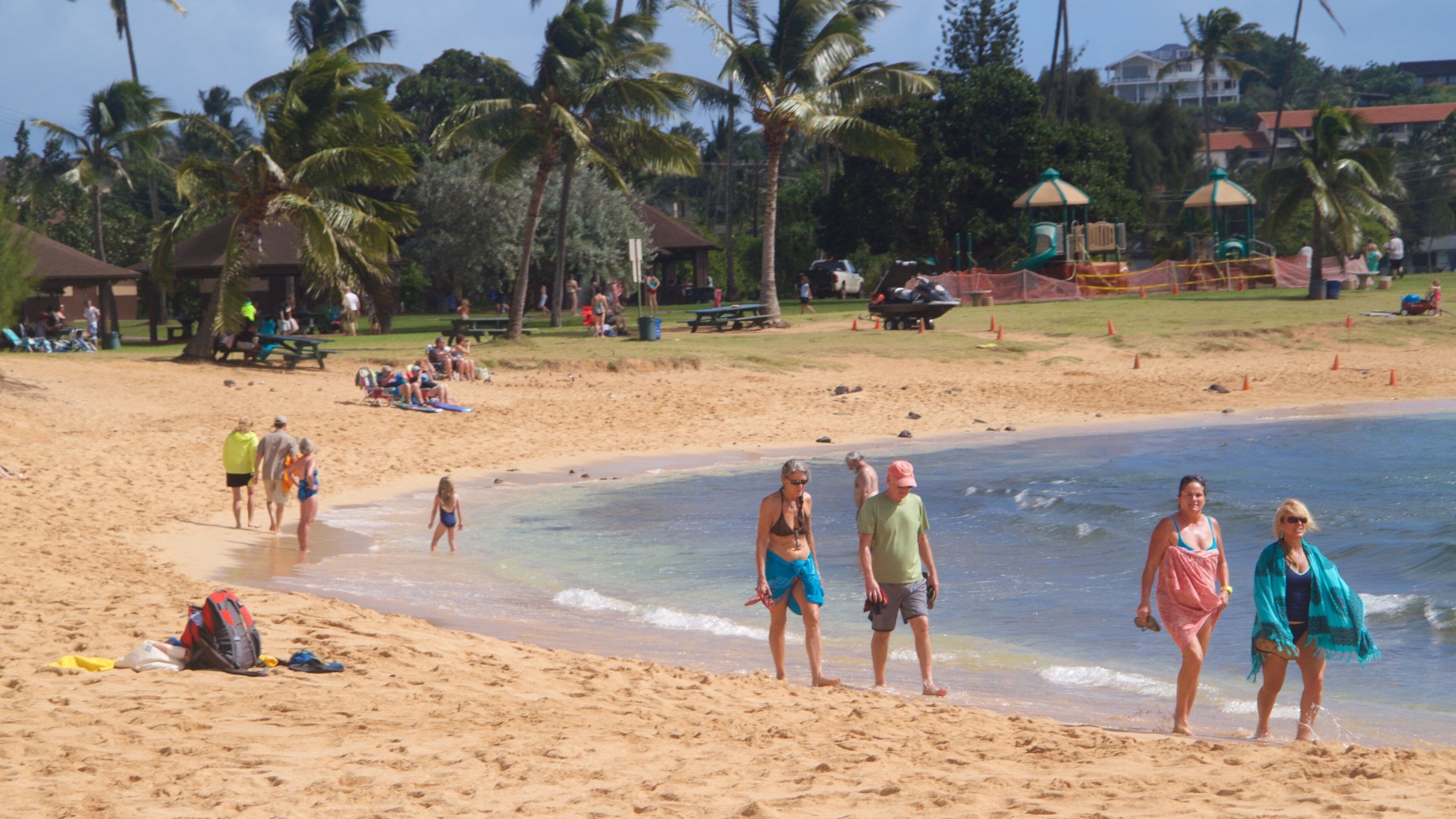 Poipu Beach featuring a sandy beach as well as a family