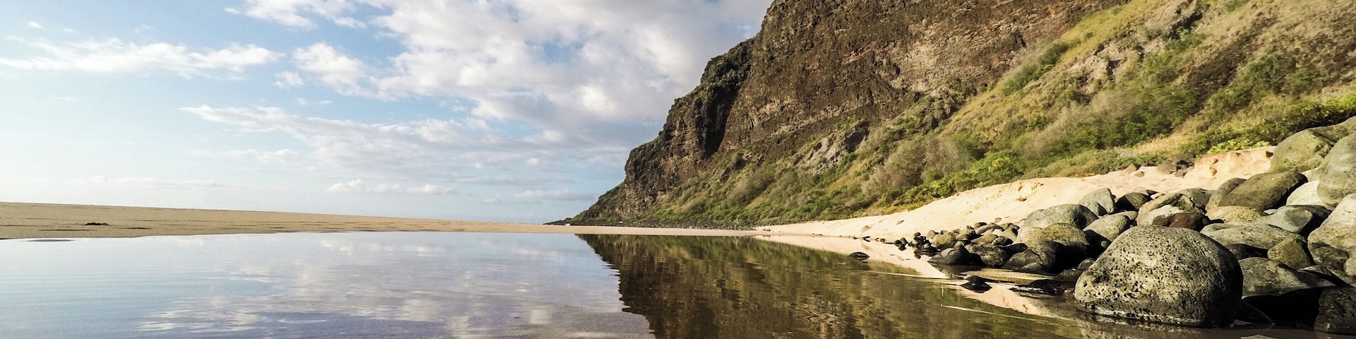 End of the road at the peaceful Polihale Beach and State Park ~ AKA ~ The longest sandy beach in all of the Hawaiian Islands. This is also the start of the remarkable Na Pali Coastline on the garden isle of Kauai. Four-wheel drive is recommended for the road leading to Polihale State Park. Rental car companies do not take emergency roadside service calls at this spot. If you still decide to go in with a two-wheel drive vehicle, be sure to stop at the local grocery store in Waimea town on your way to pick up a 12-pack of "Hawaiian Insurance"-- just in case you need to ask a local to pull you out of the sand ;)
#LifeAtExpedia #ExpediaLocalExpert #NaPaliCoast #Kauai #HawaiianIslands