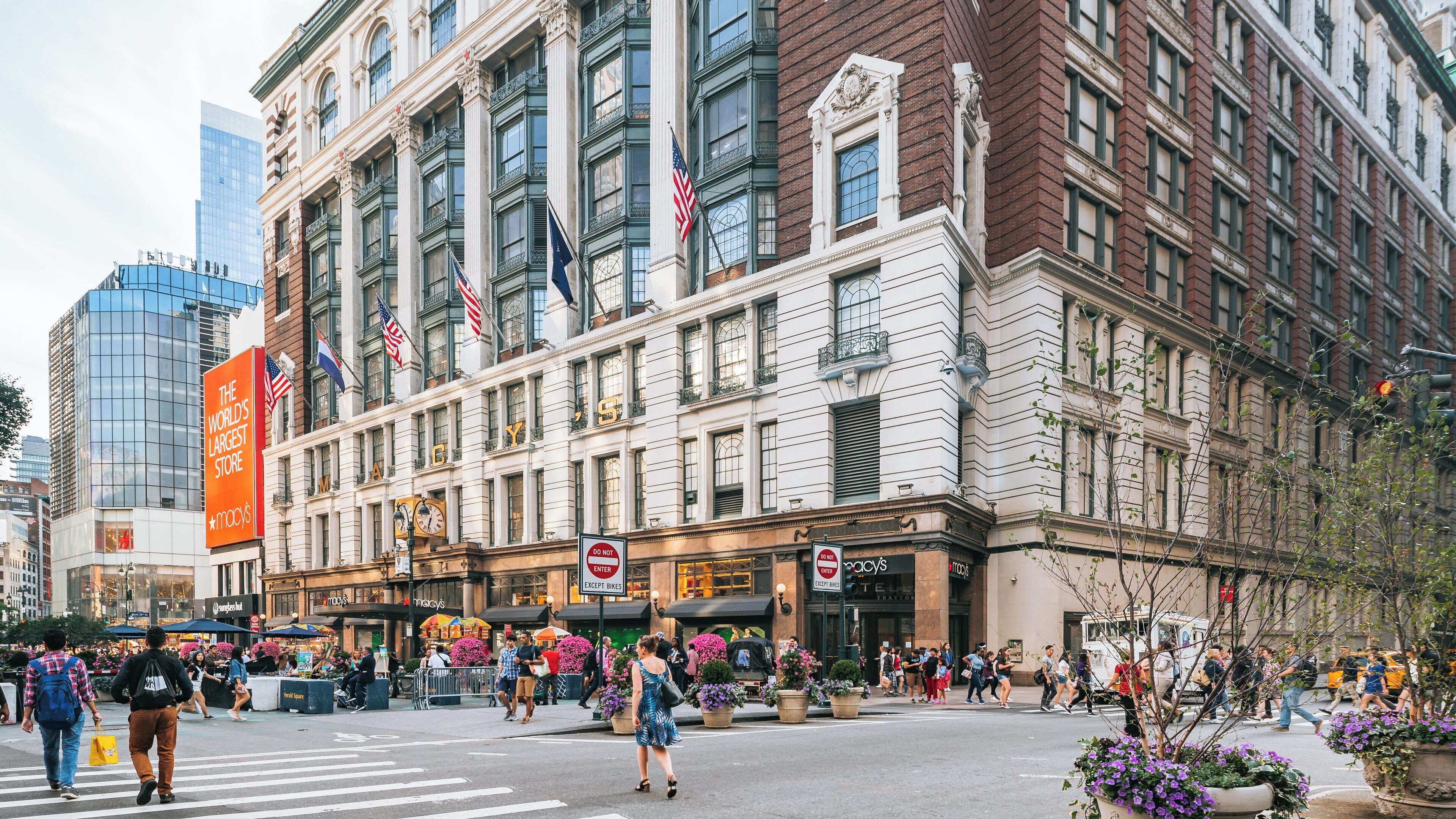 Visit to a bustling retail destination in Manhattan featuring floral displays and vibrant street activity in New York City
