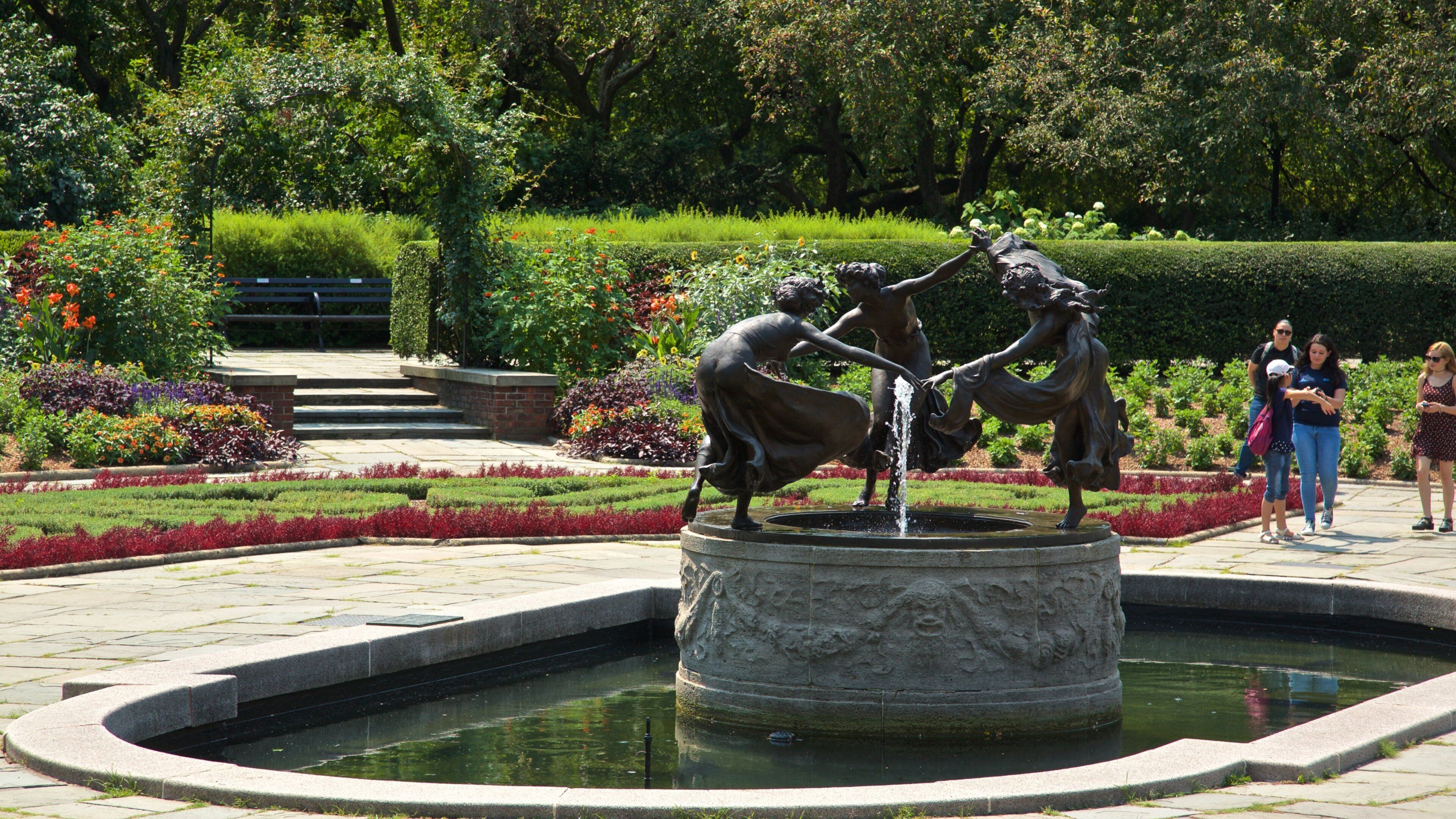 Conservatory Garden featuring a garden, outdoor art and a fountain