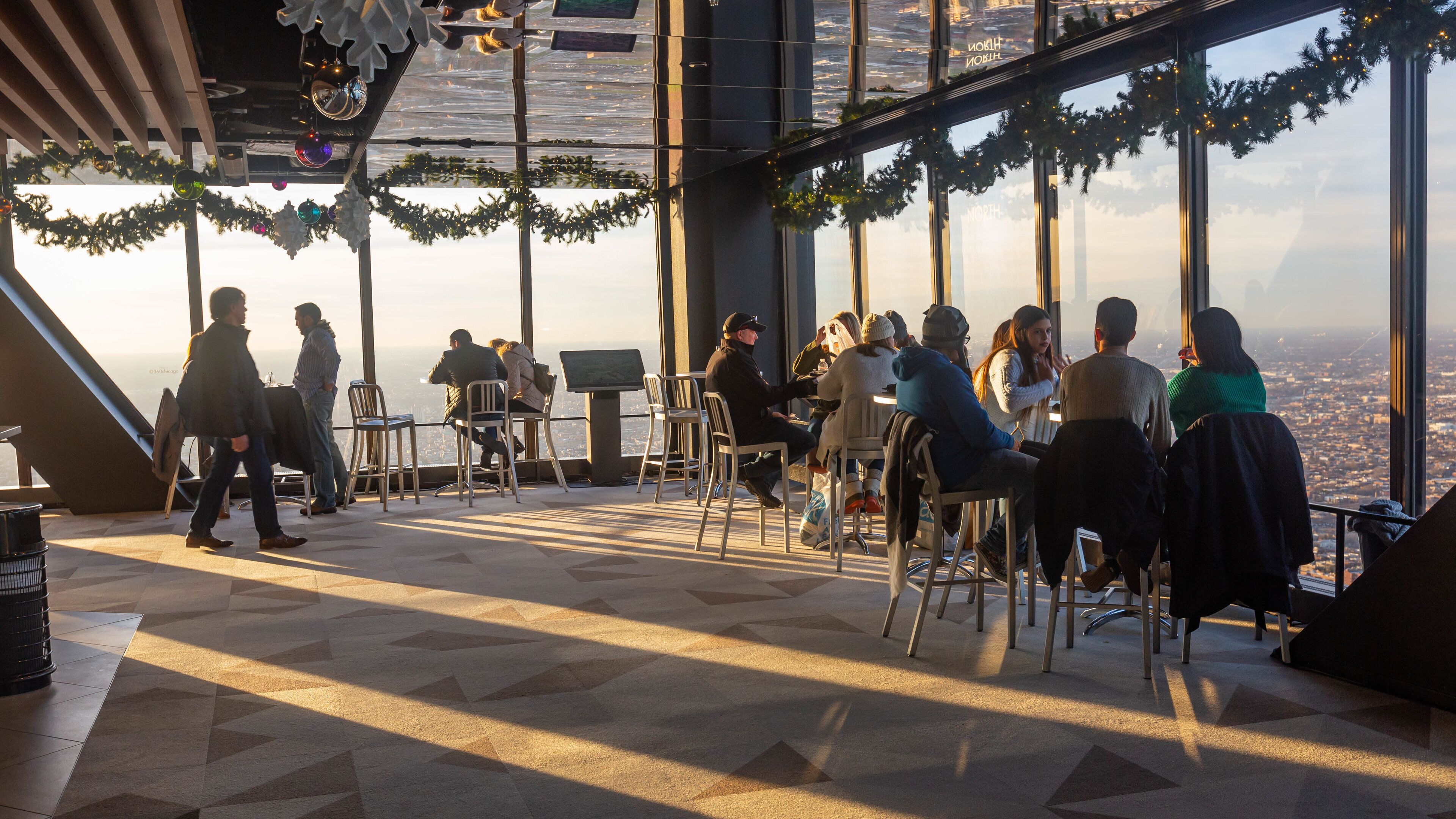 John Hancock Center featuring a sunset and interior views as well as a small group of people