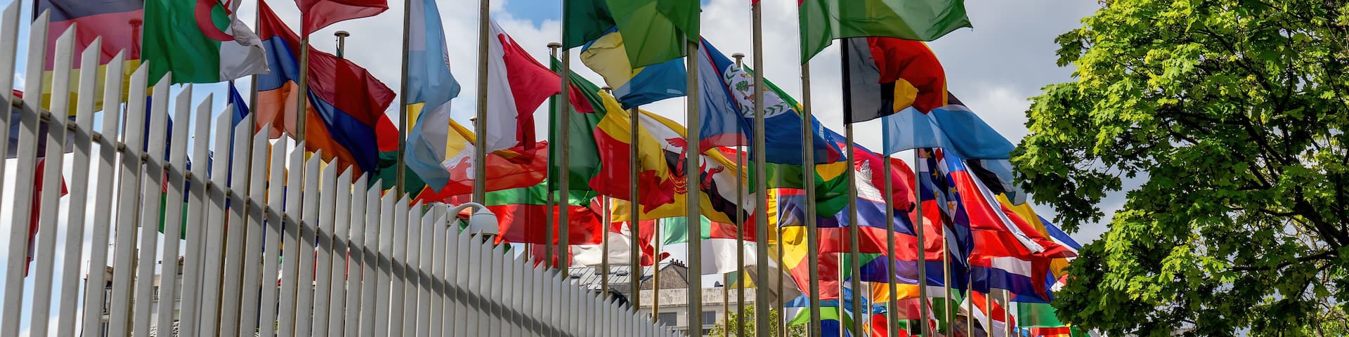 Flags fluttering in the wind in front of the UNESCO (United Nations Educational, Scientific and Cultural Organization) headquarters at 7 place de Fontenoy in Paris.