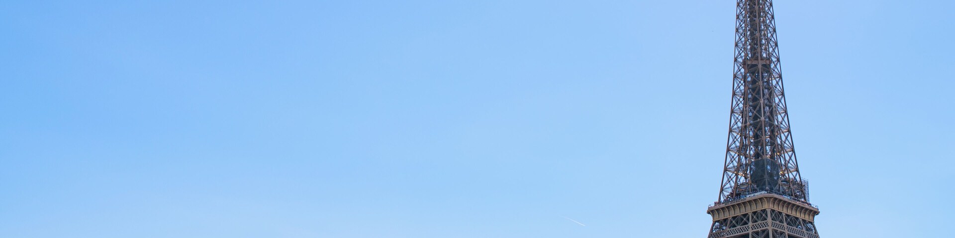 Paris Eiffel tower in France, isolated on blue sky. Travel landmark, copy space.