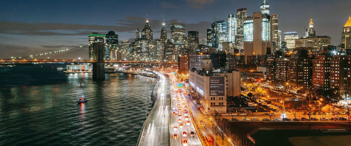 Manhattan Bridge showing a city, a river or creek and landscape views