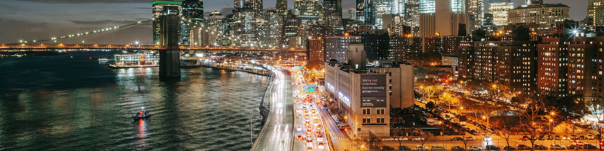 Manhattan Bridge showing a city, a river or creek and landscape views