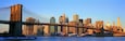 Panoramic view of Brooklyn Bridge and East River at sunrise with New York City, NY skyline post 9/11 view'