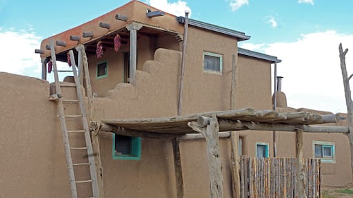Taos Pueblo (or Pueblo de Taos) is an ancient Pueblo belonging to a Taos-speaking (Tiwa)Native American tribe of Puebloan people,. It lies about 1 mile (1.6 km) north of the modern city of Toas, New Mexico. The pueblos are considered to be one of the oldest continuously inhabited communities in the United States. This has been designated a UNESCO World Heritage Site.