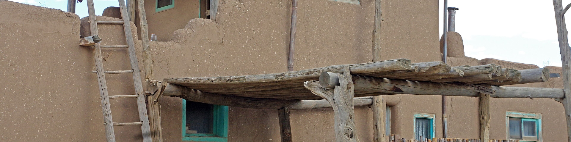 Taos Pueblo (or Pueblo de Taos) is an ancient Pueblo belonging to a Taos-speaking (Tiwa)Native American tribe of Puebloan people,. It lies about 1 mile (1.6 km) north of the modern city of Toas, New Mexico. The pueblos are considered to be one of the oldest continuously inhabited communities in the United States. This has been designated a UNESCO World Heritage Site.