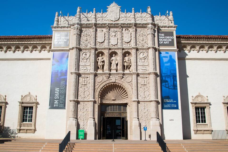 The San Diego Museum of Art with ornate architecture and banners advertising exhibitions.