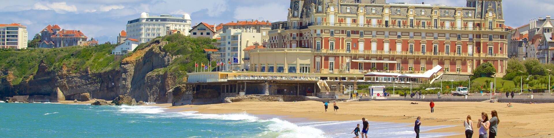 Grand Beach featuring a coastal town and a sandy beach