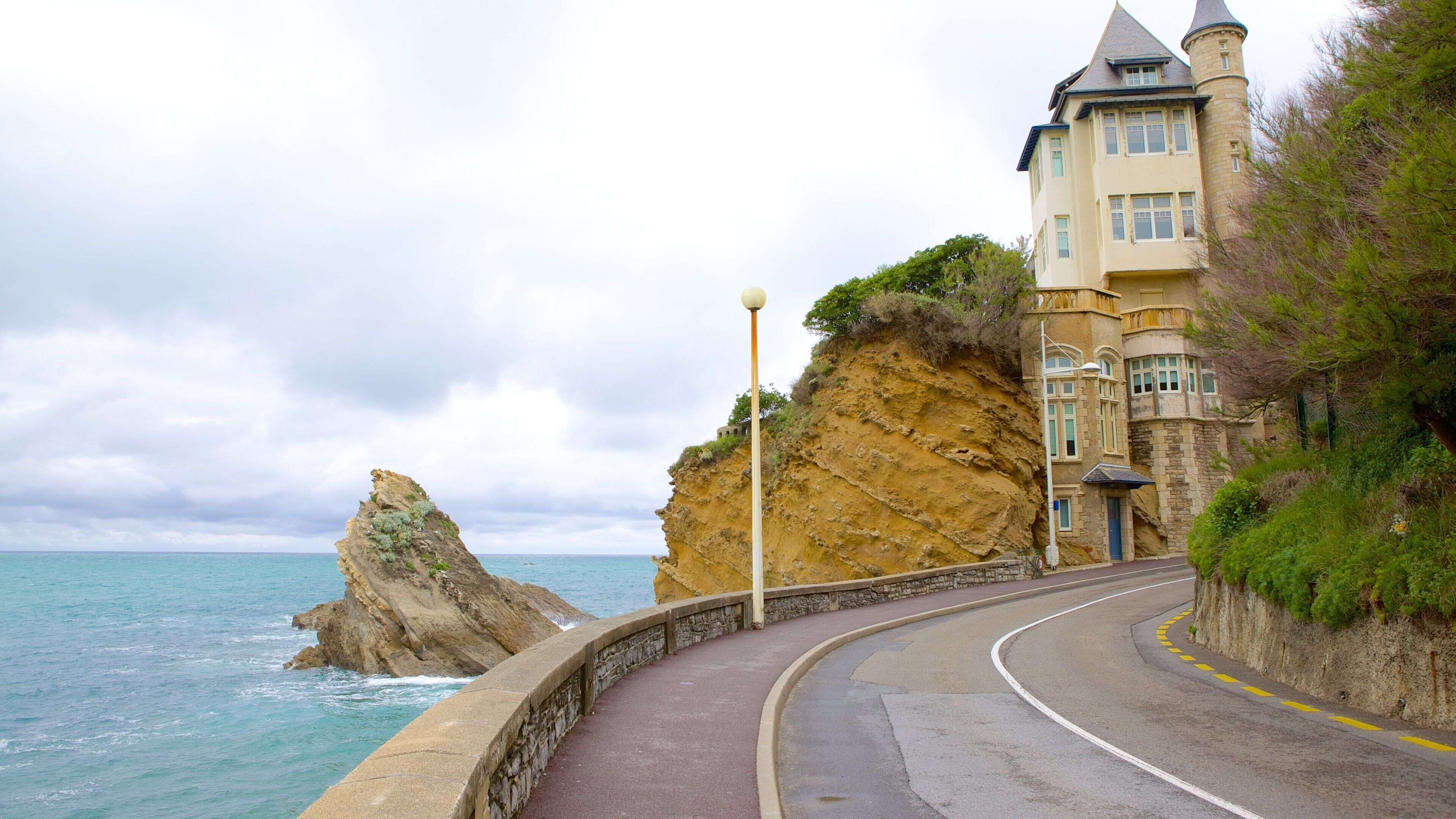 Cote des Basques which includes rocky coastline and a house