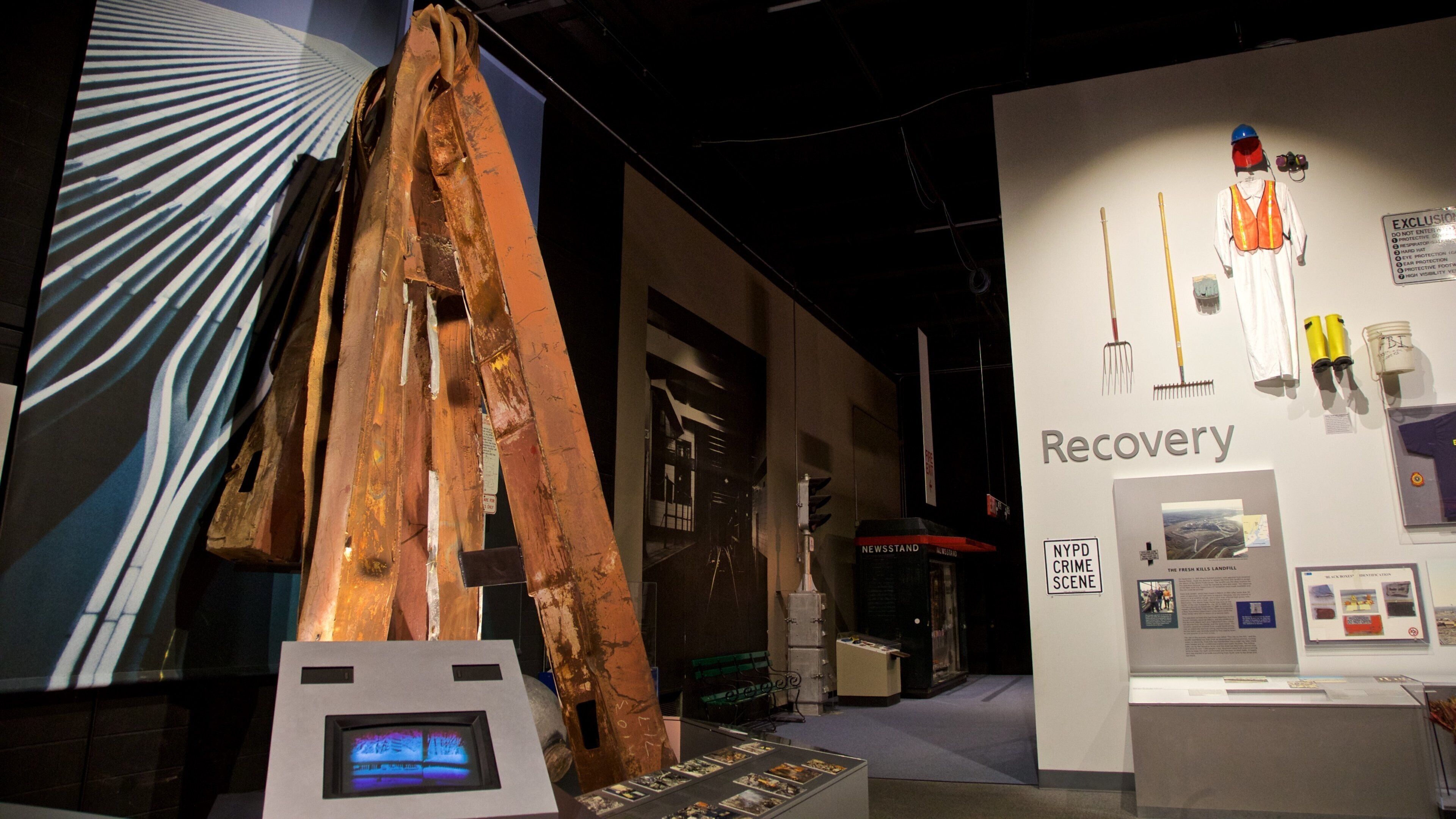 A museum exhibit with a large metal structure, a display of tools, and a sign labeled 'Recovery'.