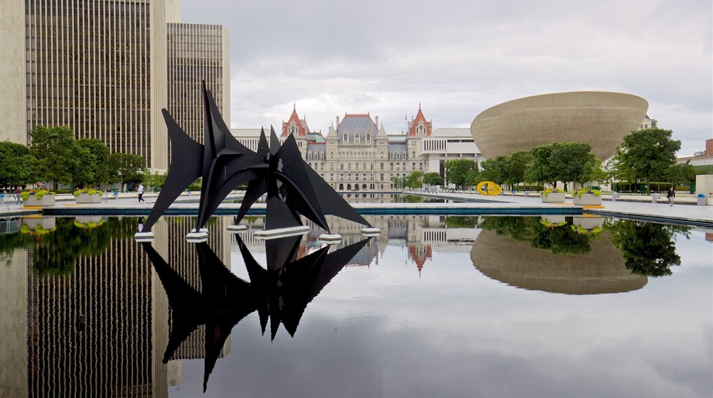 Governor Nelson A. Rockefeller Empire State Plaza showing a pond, a city and outdoor art