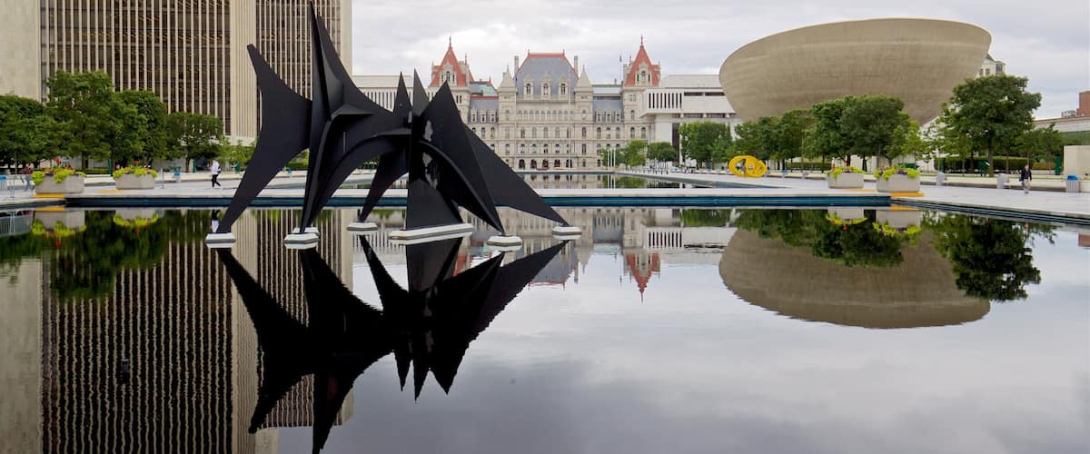 Governor Nelson A. Rockefeller Empire State Plaza showing outdoor art, a pond and modern architecture