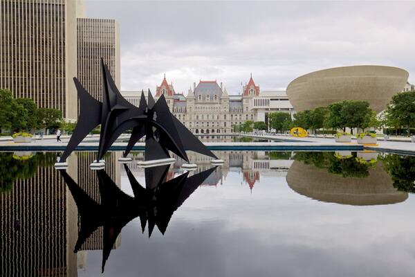 Governor Nelson A. Rockefeller Empire State Plaza showing outdoor art, a pond and modern architecture