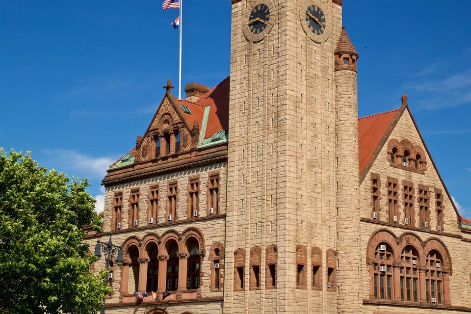 Een grote stenen kerk met een klokkentoren, gebogen ramen en een vlaggenmast met de Amerikaanse vlag.