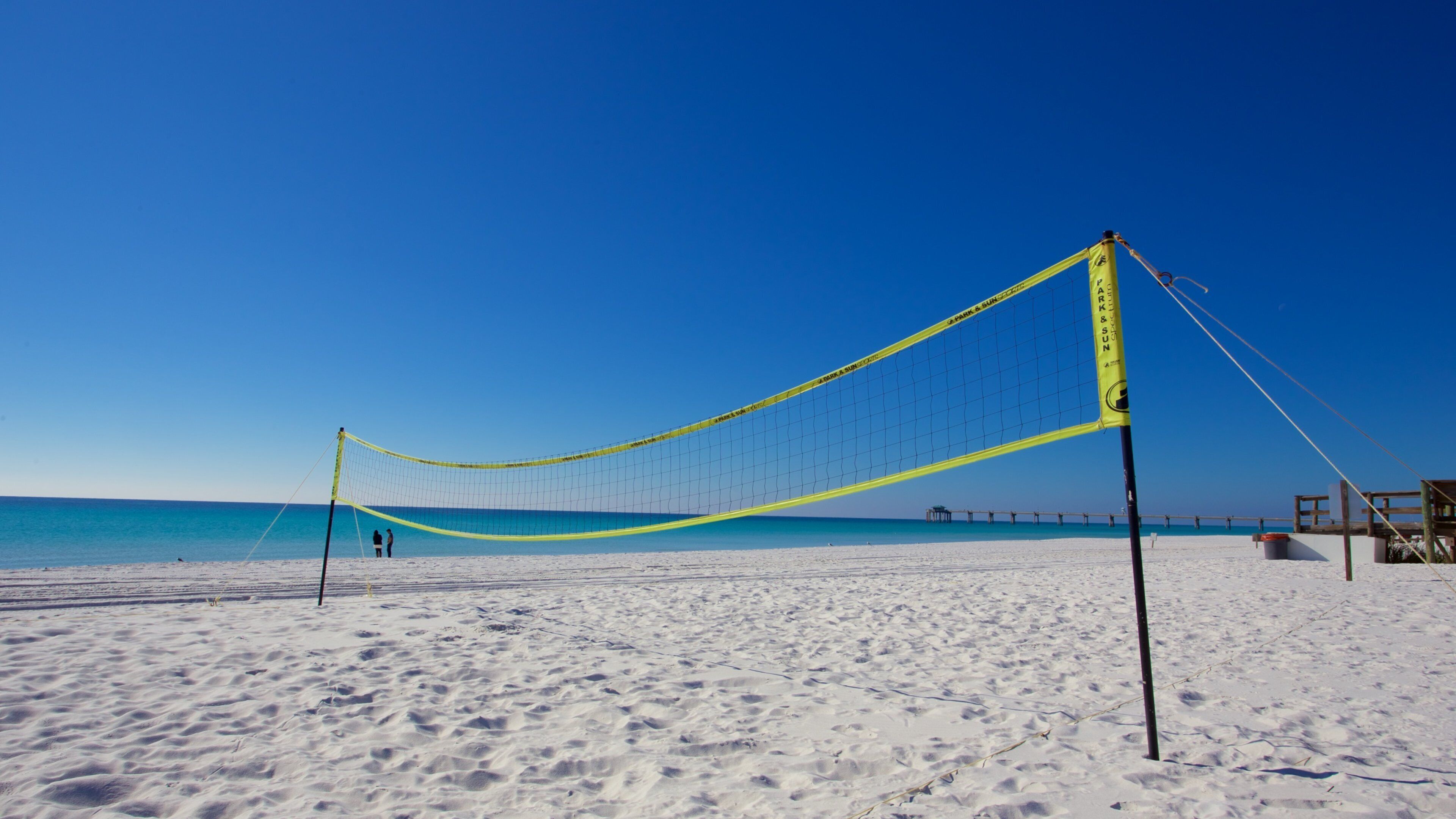 Okaloosa Island which includes a sandy beach and a sporting event