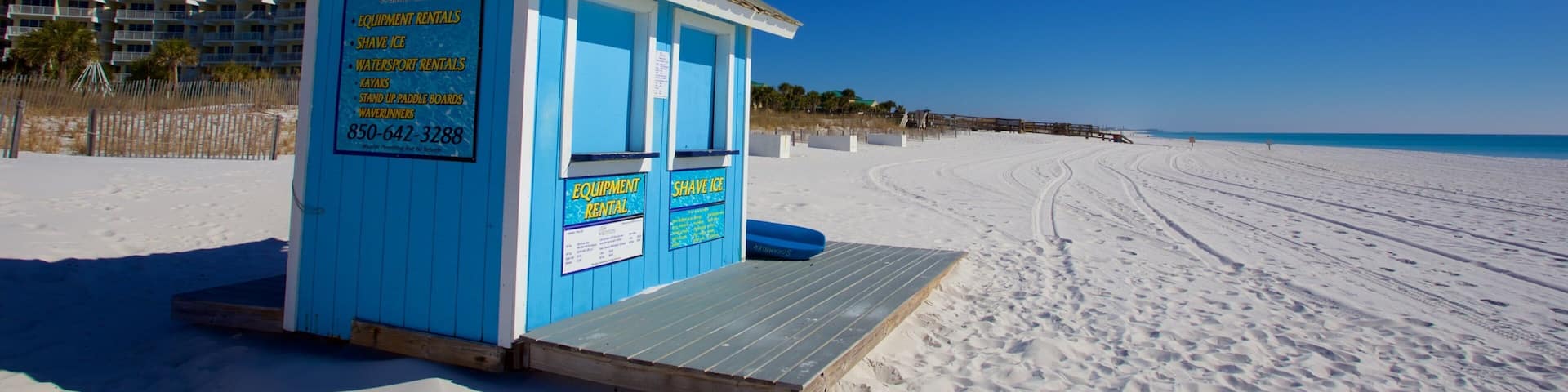 A beach rental shack with equipment rentals, shave ice, and kayak rentals.