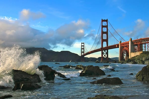 Baker Beach offering stunning views of Golden Gate Bridge and crashing waves along the shoreline in San Francisco