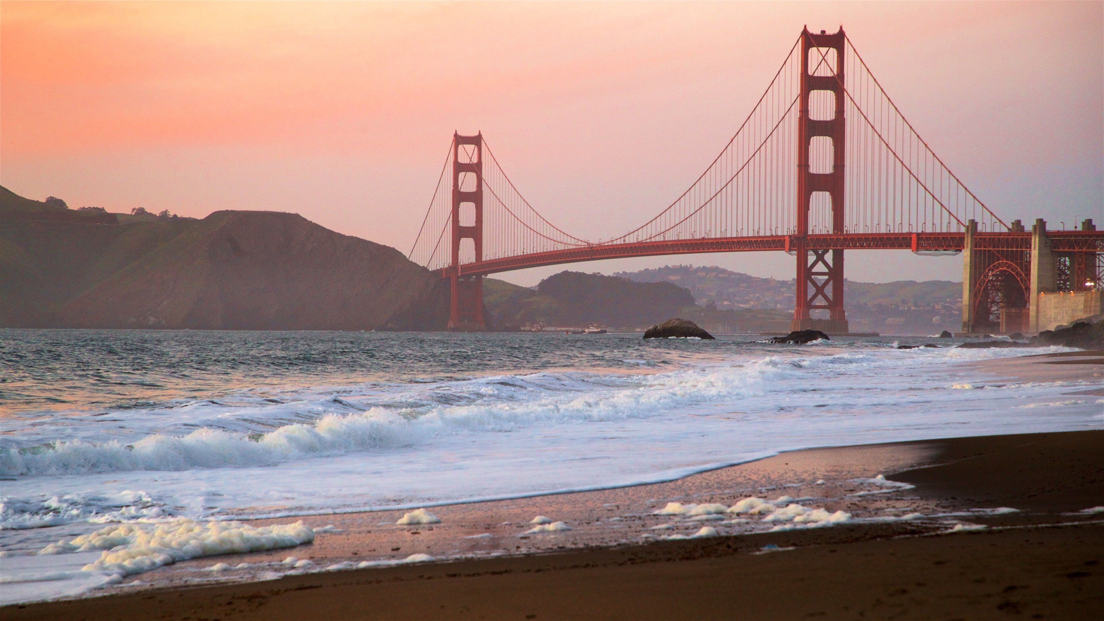 Golden Gate Bridge showing a bridge, a sunset and waves