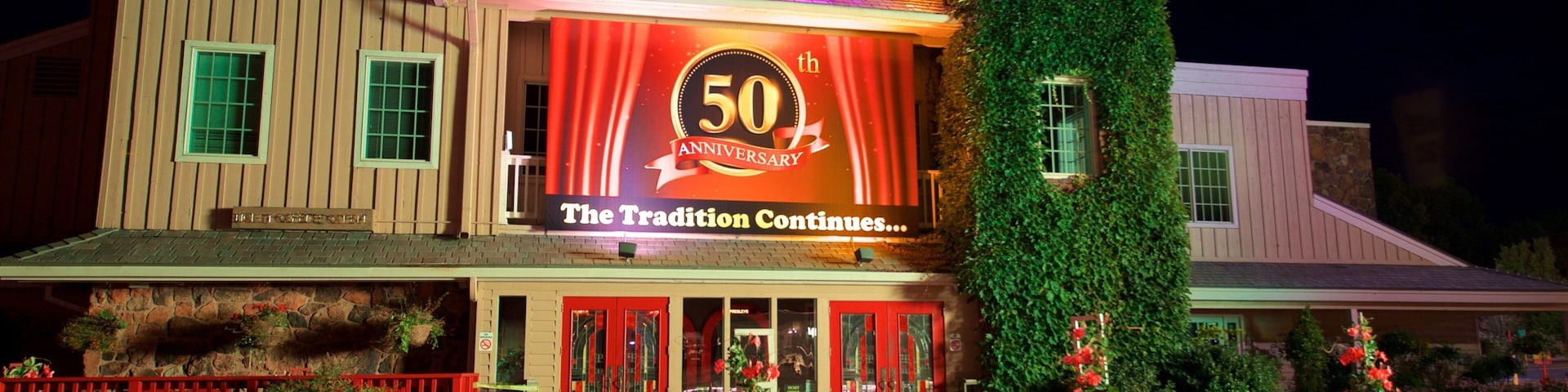 Presley\'s Country Jubilee Theater ofreciendo escenas de noche, señalización y flores
